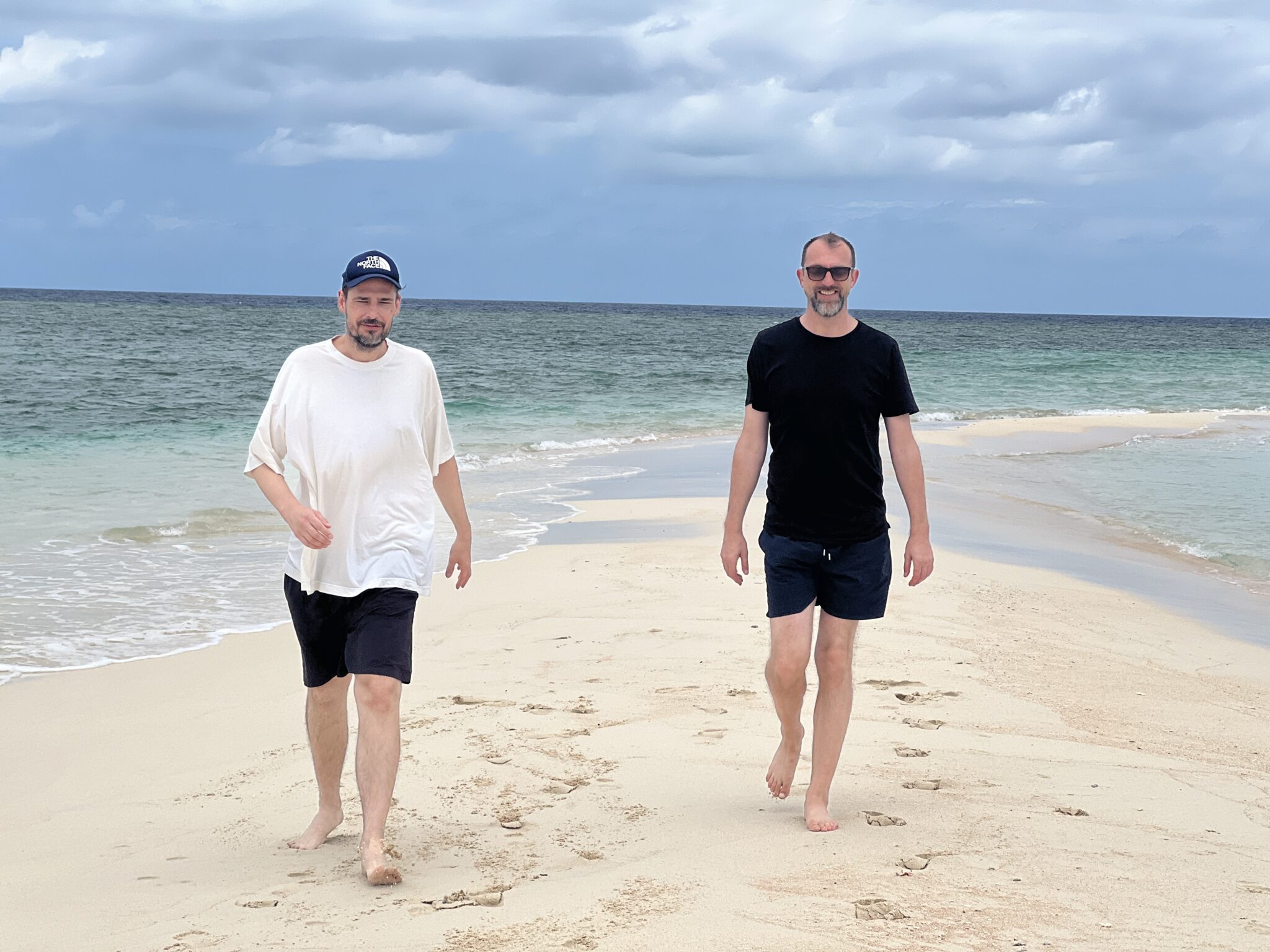 Jochen und Michael laufen am Strand entlang